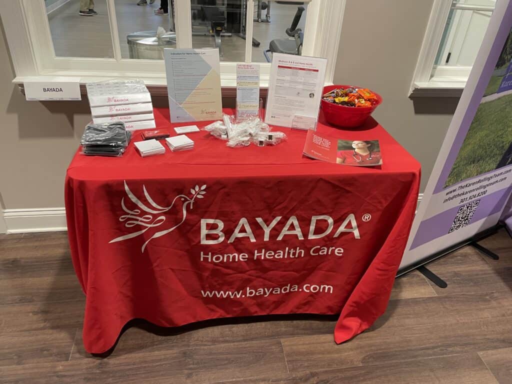 This is a photograph of Bayada Home Health Care's booth at Cadence Living Olney in February 2022. 