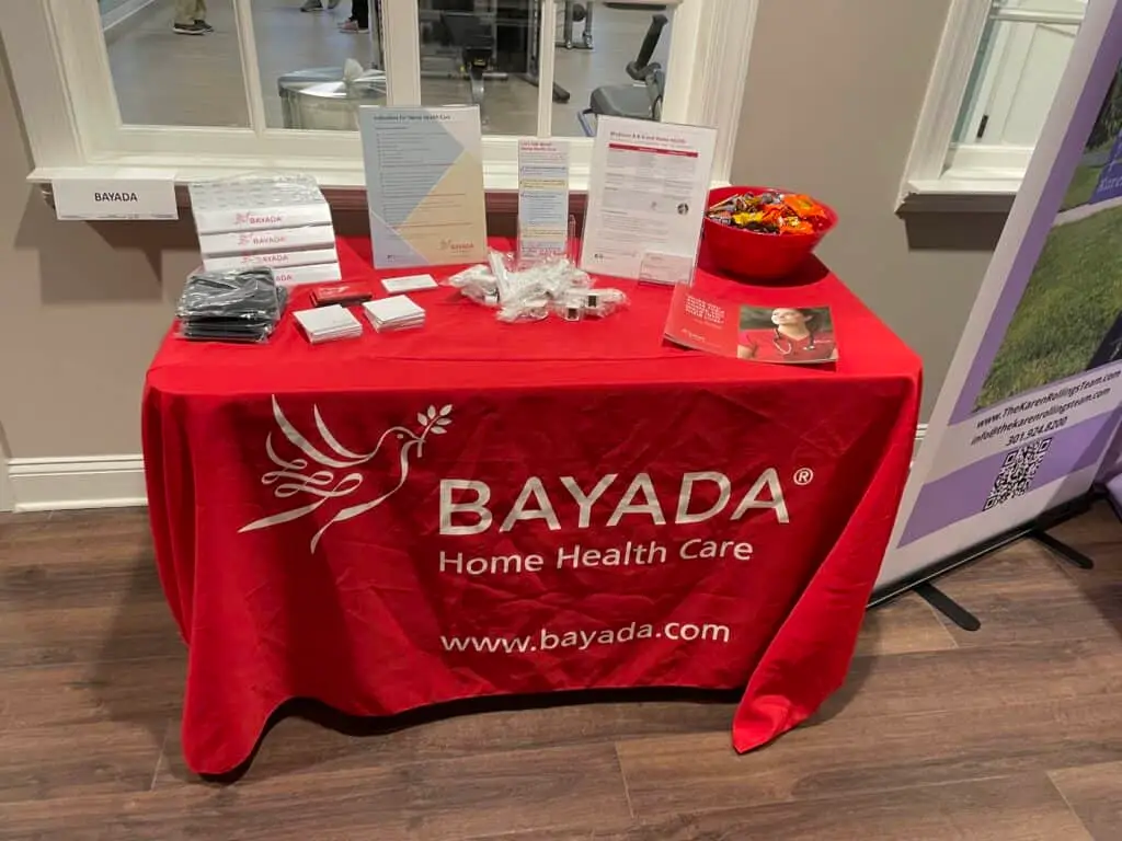 This is a photograph of Bayada Home Health Care's booth at Cadence Living Olney in February 2022. 