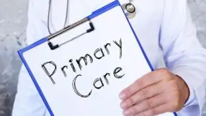 This is a picture of a primary care doctor holding a clipboard that says, "Primary care."