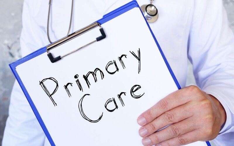 This is a picture of a primary care doctor holding a clipboard that says, "Primary care."
