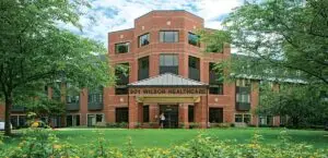 This is an external photograph of Wilson Health Care Center - part of Asbury Methodist Village - in Gaithersburg, Maryland. 